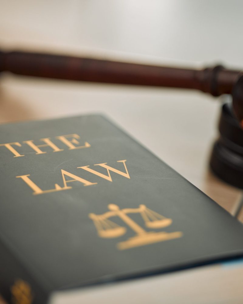 Justice law book and gavel in court for truth, freedom and legal system for rights, faith and const.